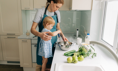 Parent and child cooking together