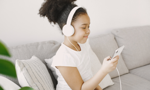Child happily listening to music